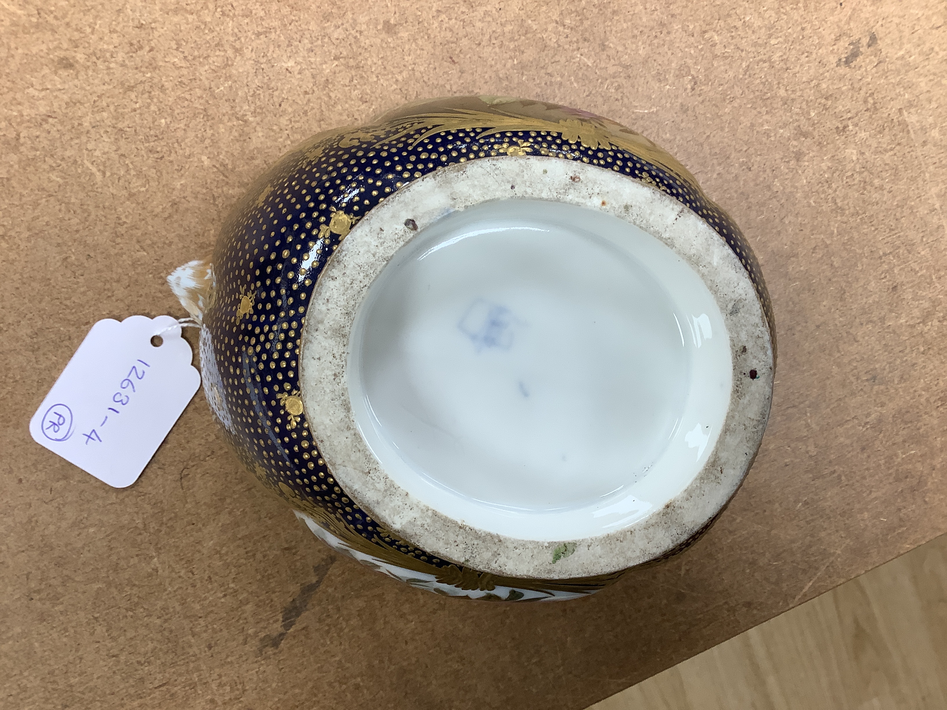 A pair of 19th century Paris porcelain cache pot hand painted with flowers and gilded decoration, 12cm high